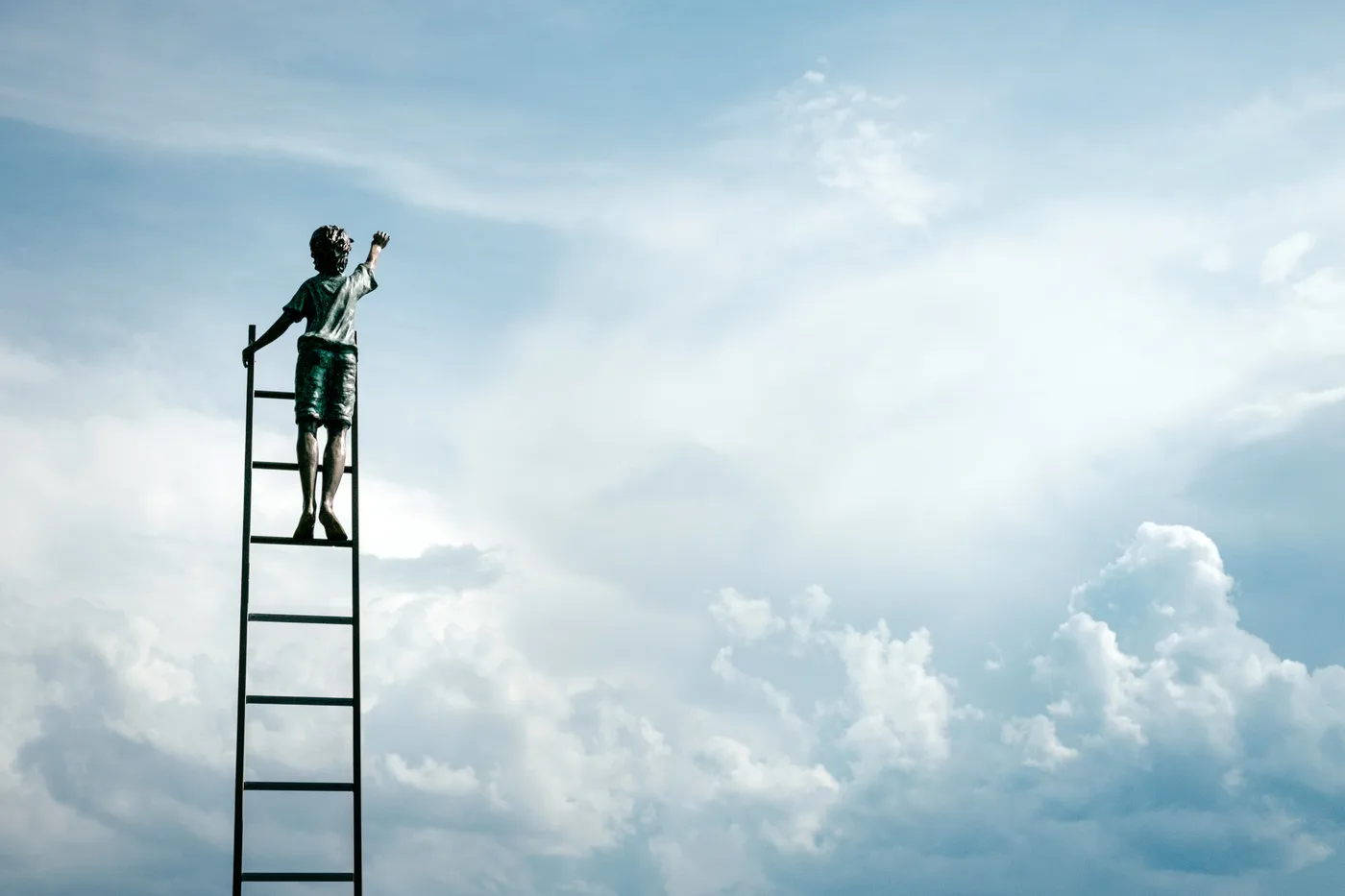 Image of a boy climbing the ladder to the clouds